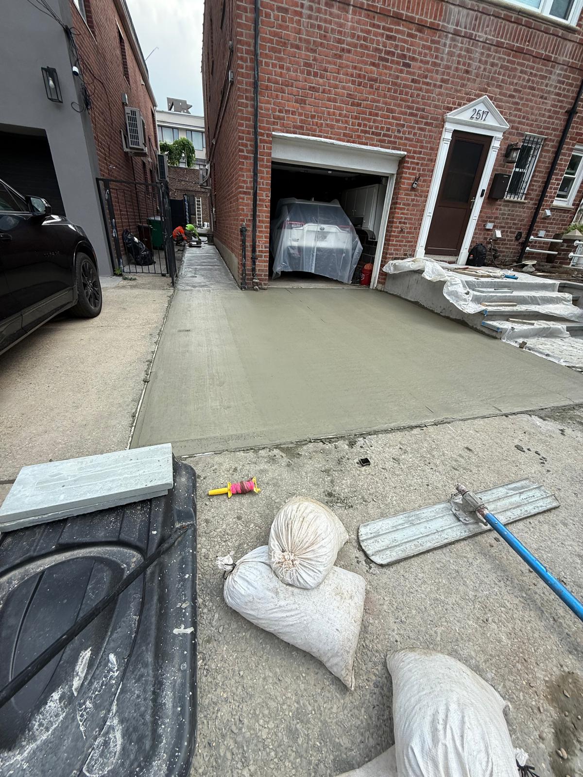 Freshly poured concrete driveway and walkway repair by Rio Branco Sidewalk Repair in New York City
